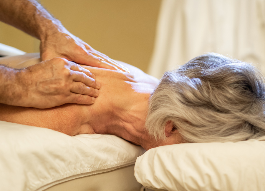 Senior getting a message, treatments for seniors